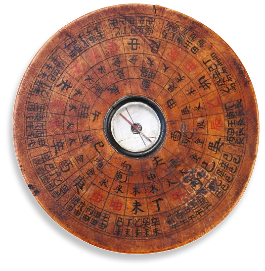 A vintage wooden Feng Shui Luopan compass with a central needle, displaying the 24 Mountains and Chinese characters.